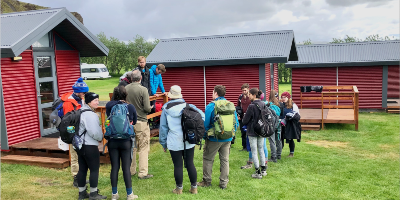 Students standing at a campsite