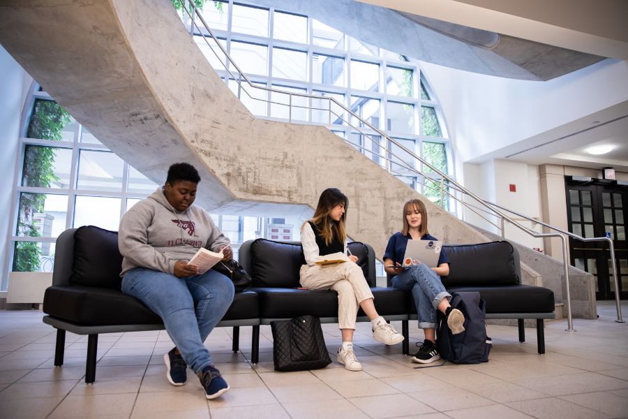 Three students sitting in the common area of the Faculty of Arts building
