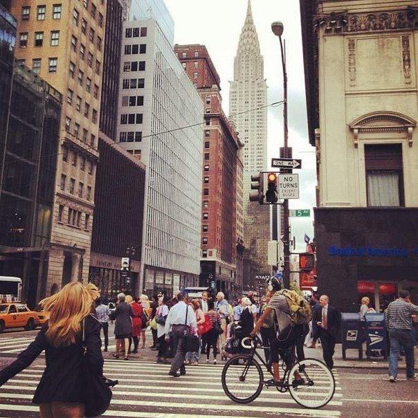 Street view with people walking and biking