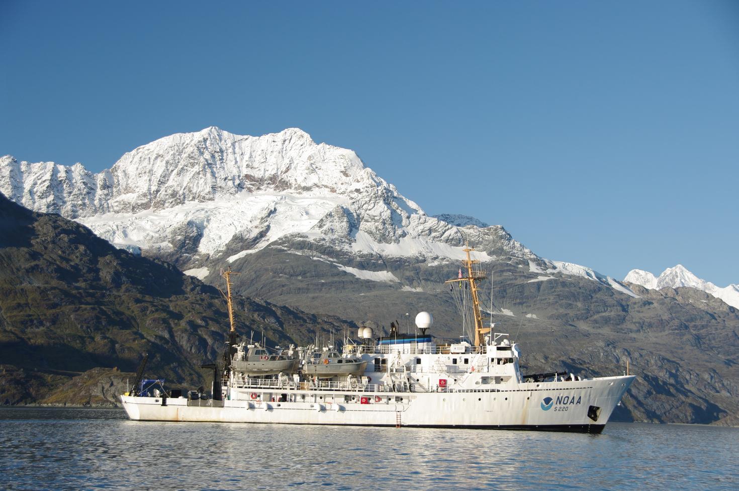 Boat on the water with mountains in the back