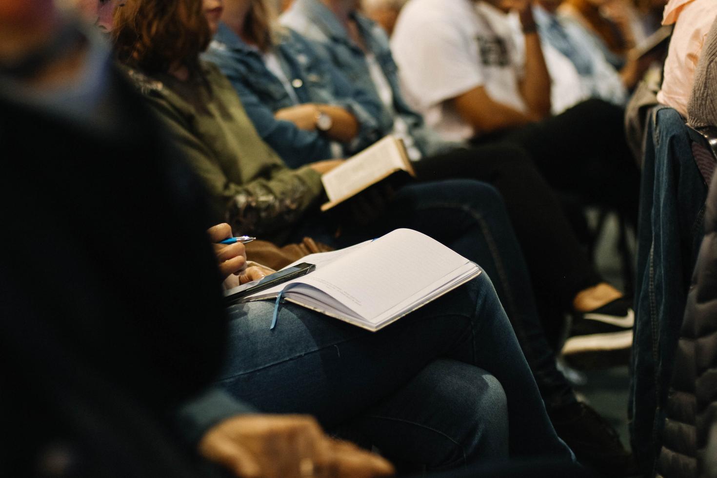 Student in classroom with notebook on lap