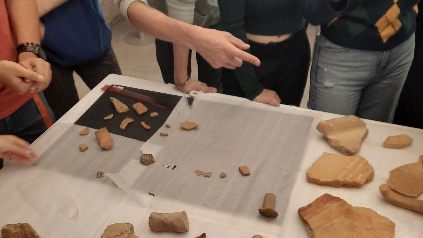 Students pointing to the artifacts
