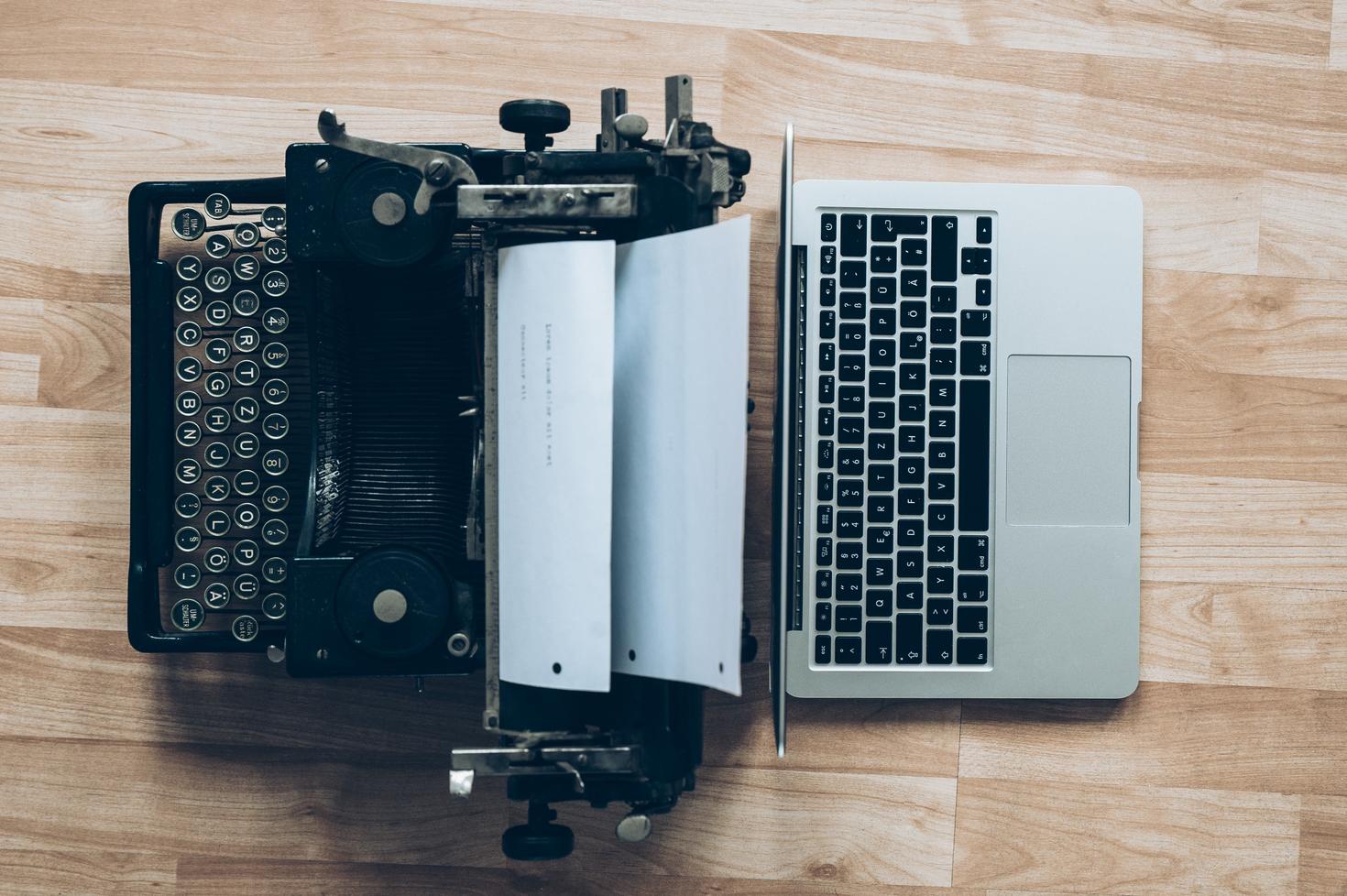 Typewriter and laptop back to back