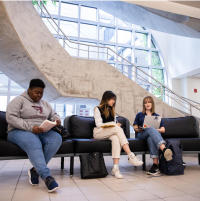 Students sitting on a bench indoors