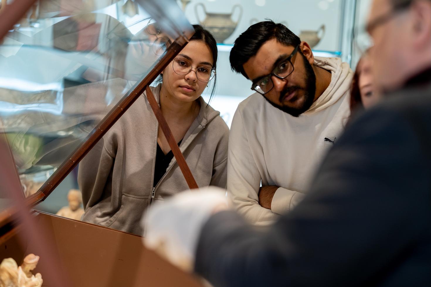 Students looking at an antique piece
