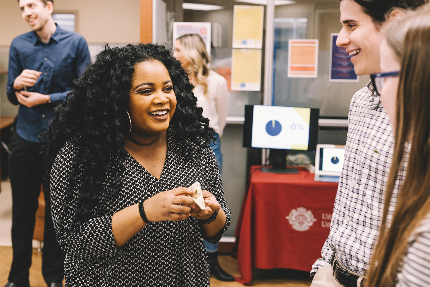 A student explaining her research at an exhibit