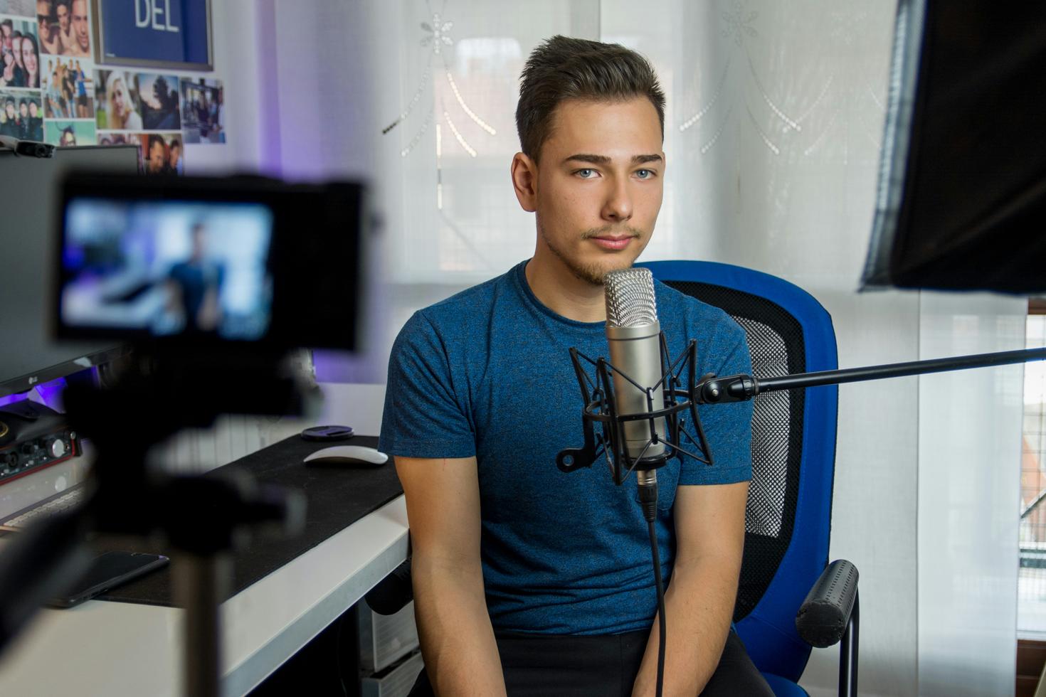 Young journalist in front of mic and camera