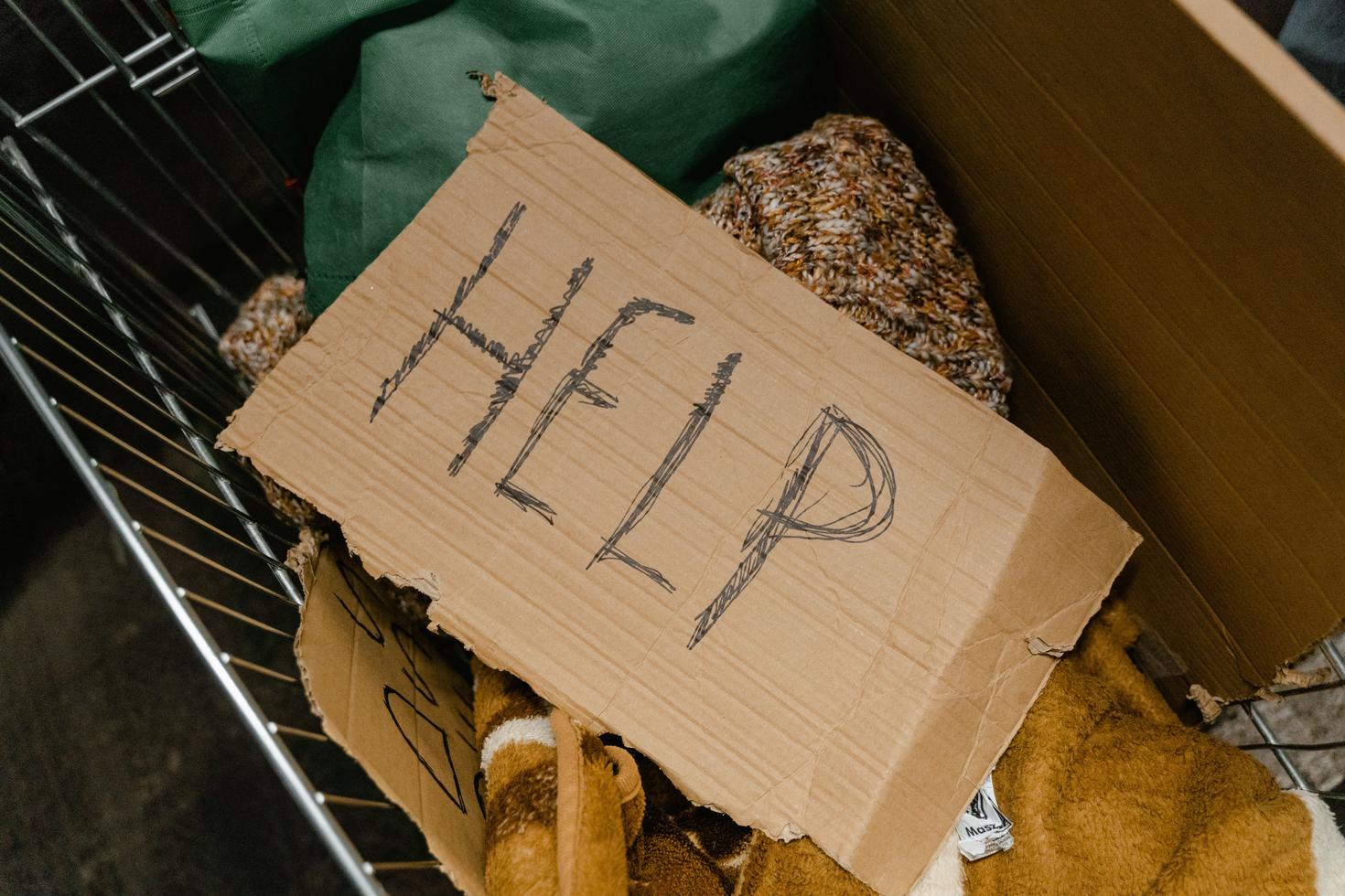 A cardboard sign saying "Help" 