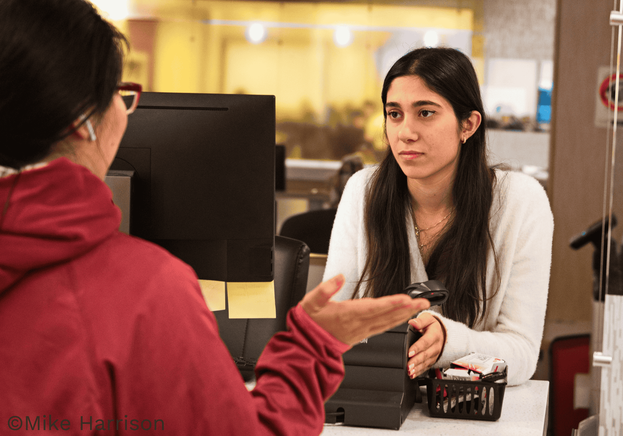 Receptionist helping a student at the resource center