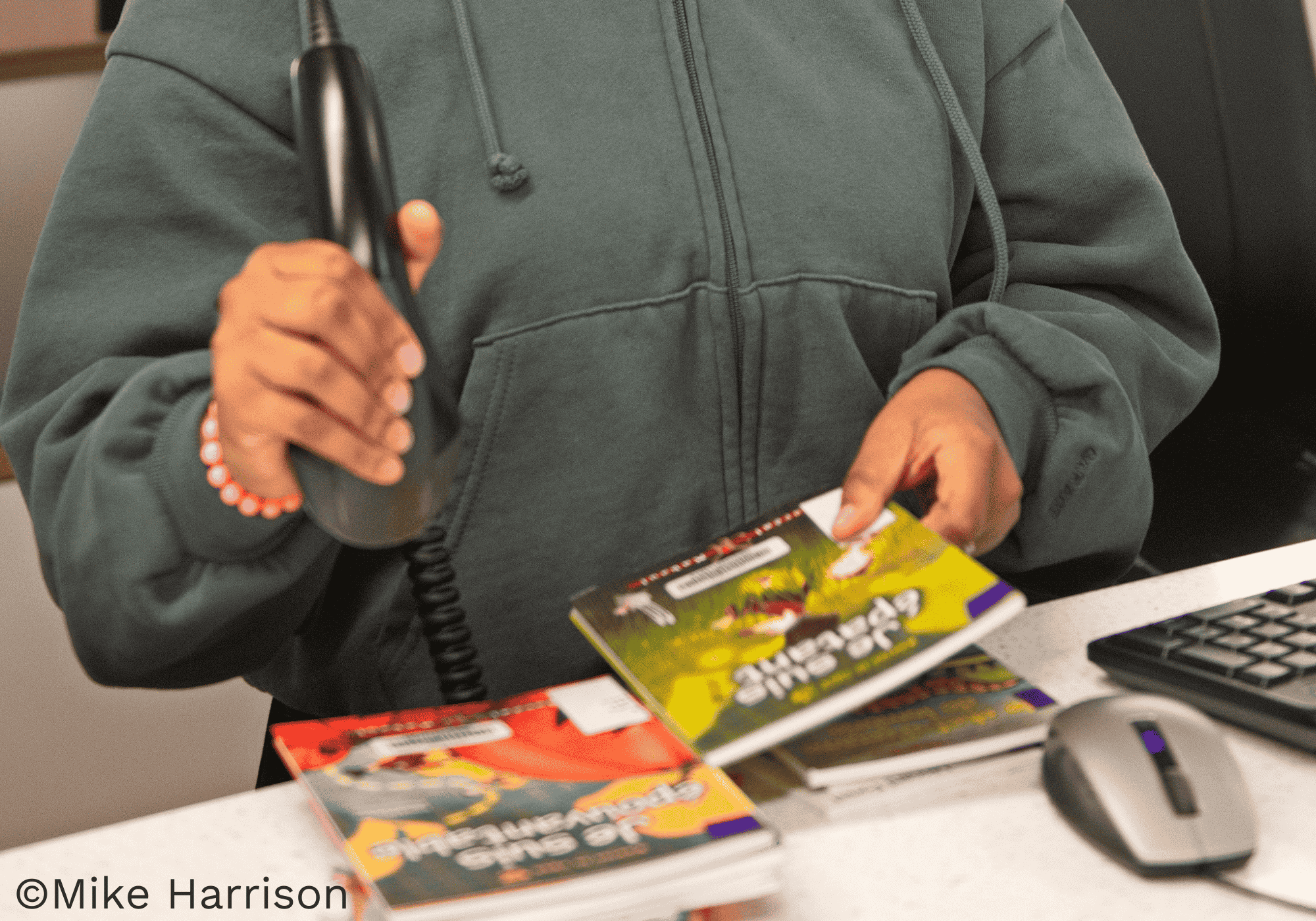 Receptionist scanning books at the Resource Center