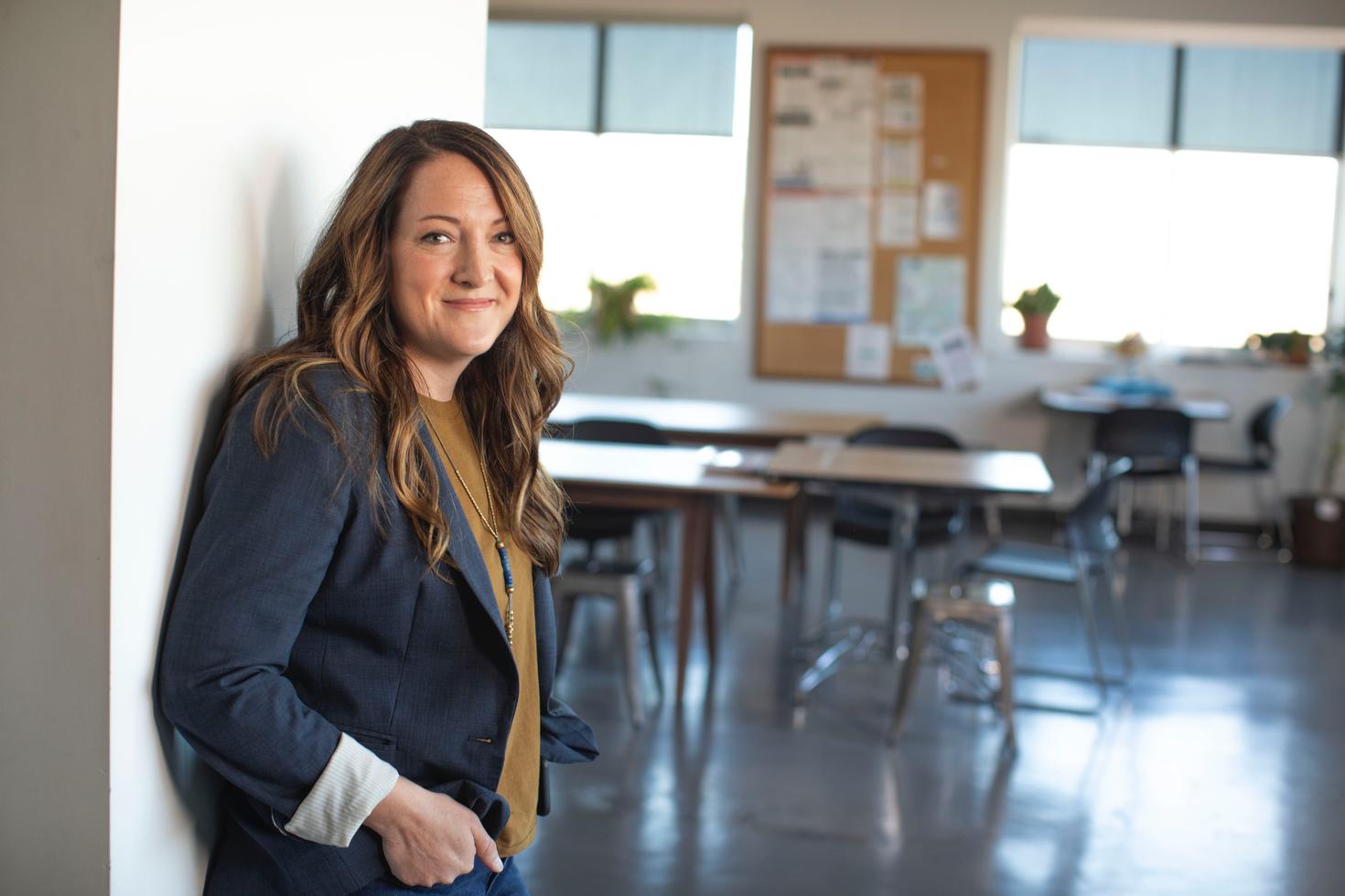 Teacher standing outside classroom.