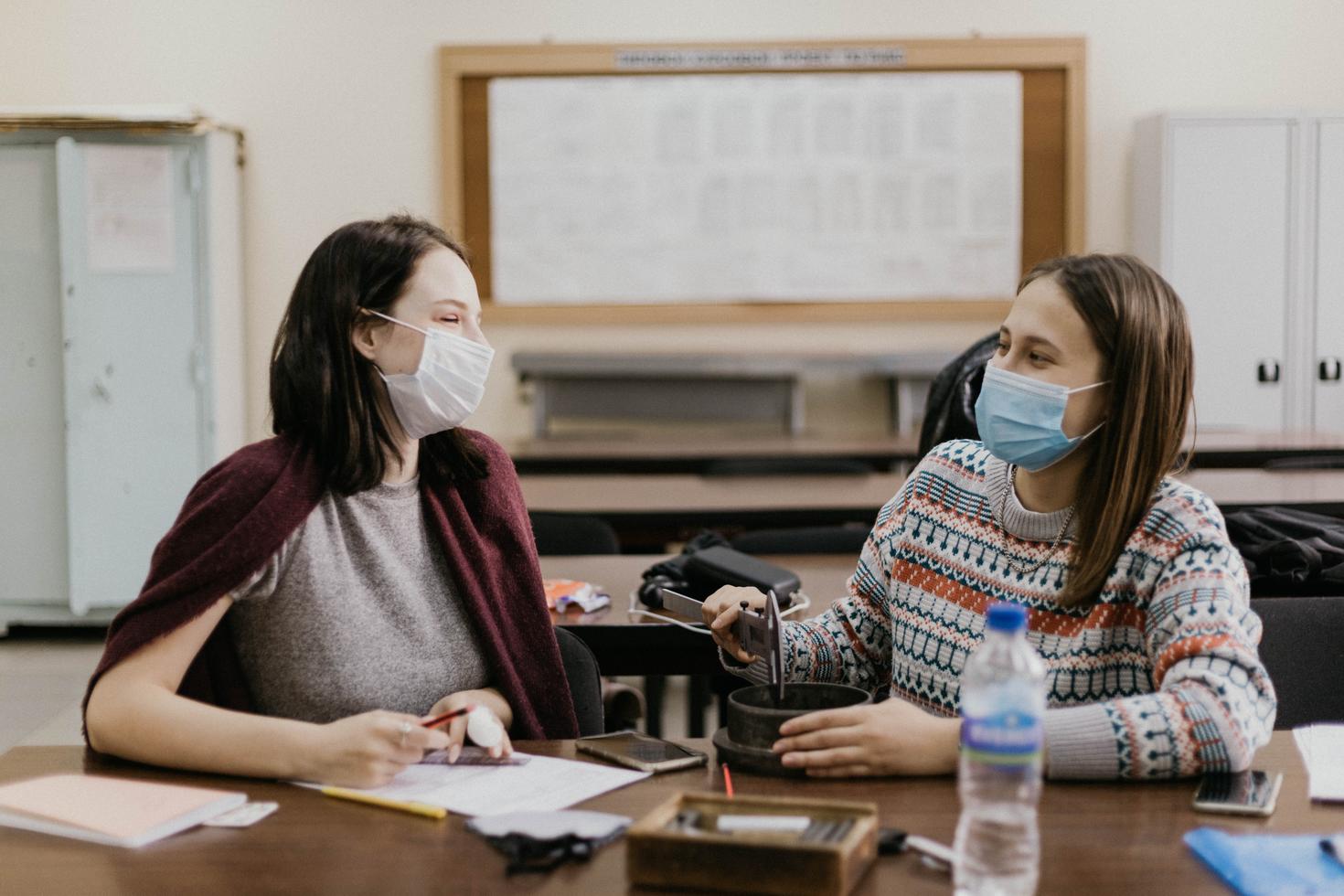 Students talking with mask on their faces
