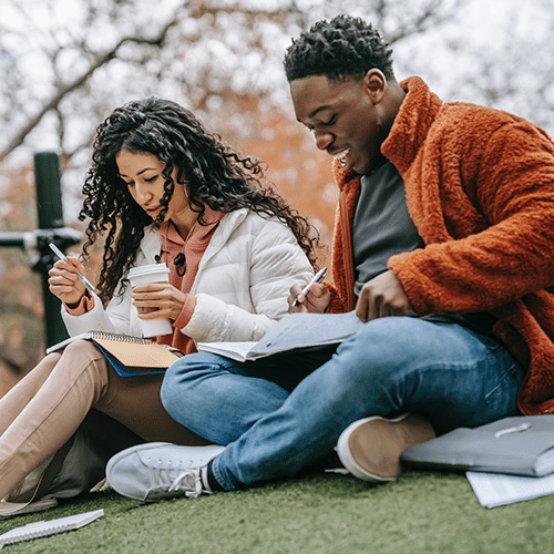 Two students studying outside.