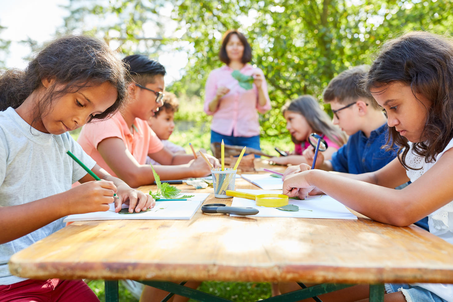 Children drawing in a garden