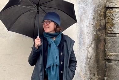 Person standing in the street holding an umbrella