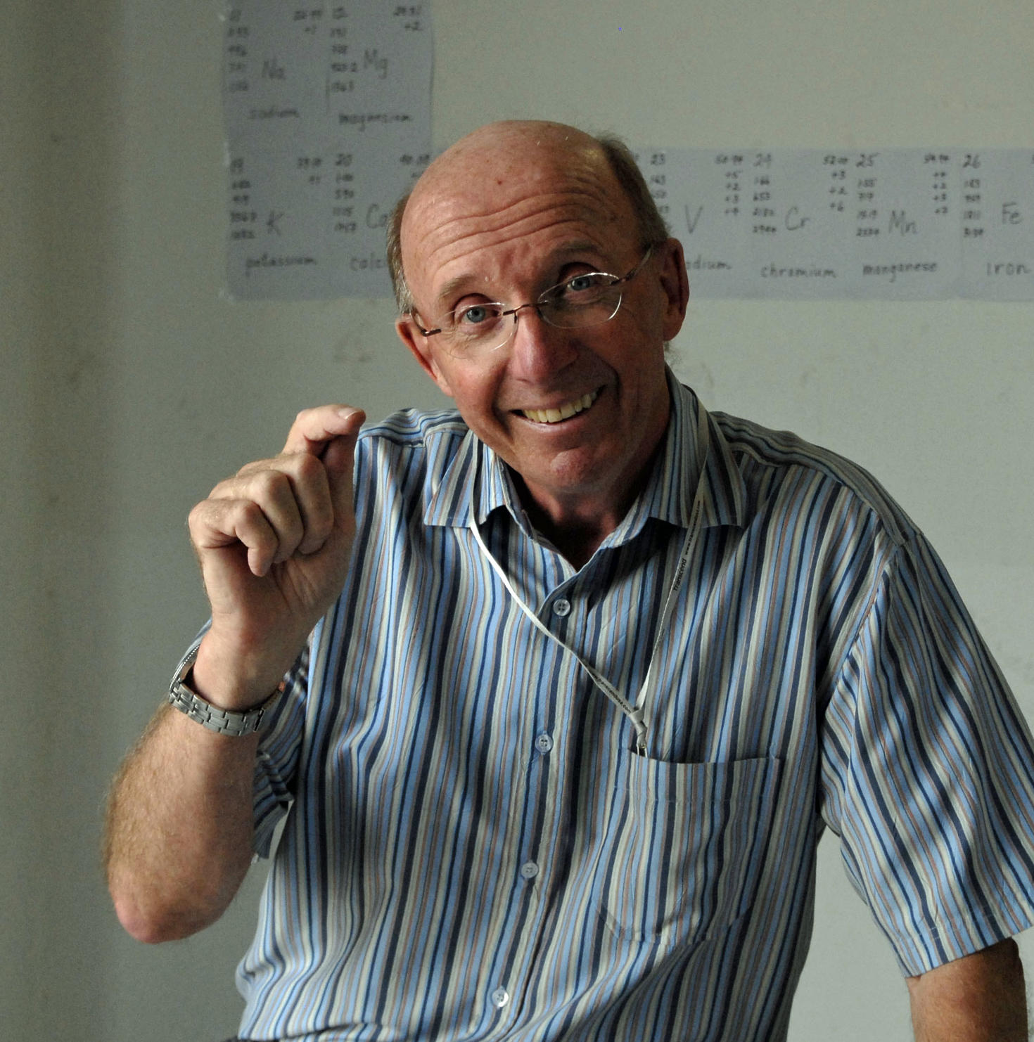 Professor smiling and pointing at something