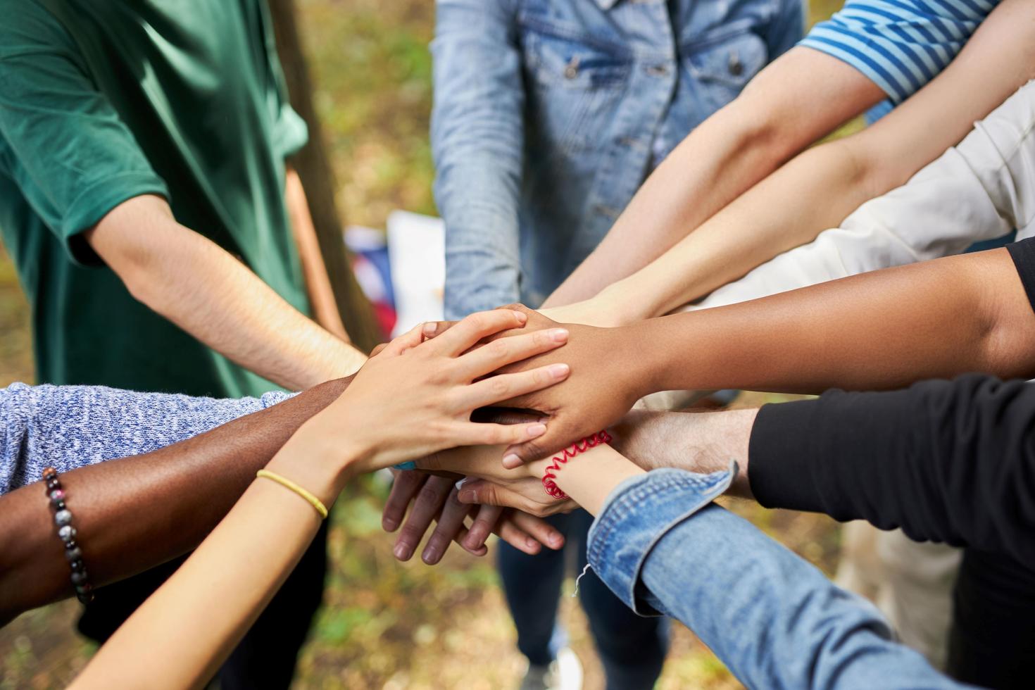 Mixed raced international group holds hands