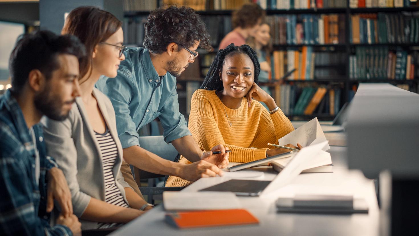Multicultural students around a desk