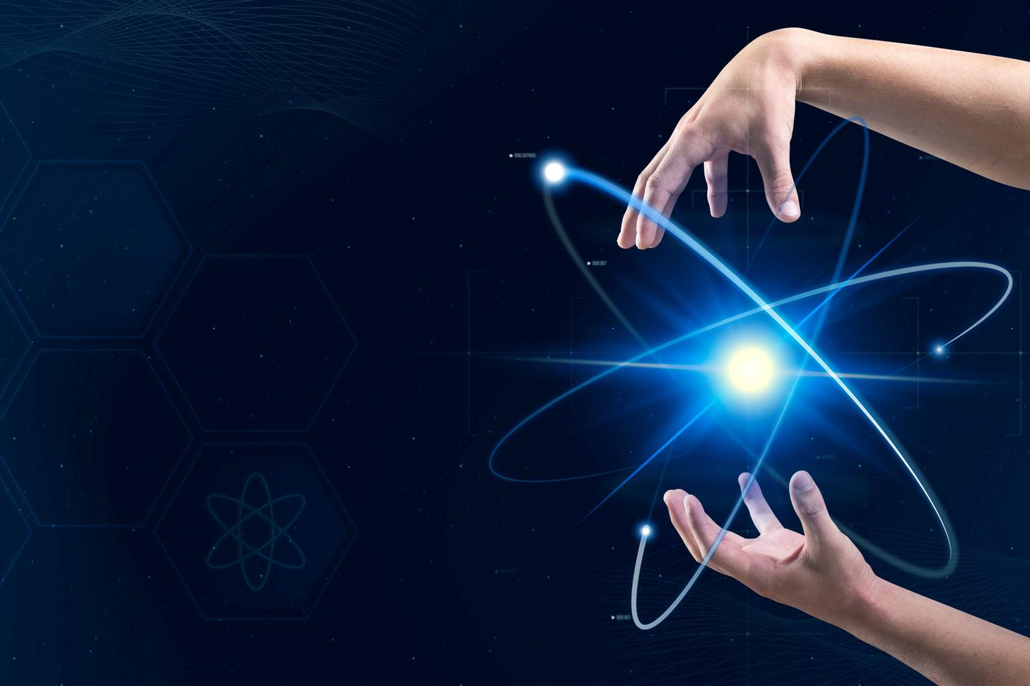 Hands manipulating an atom