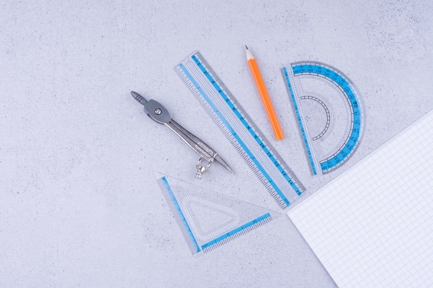 A piece of blank paper with math tools around