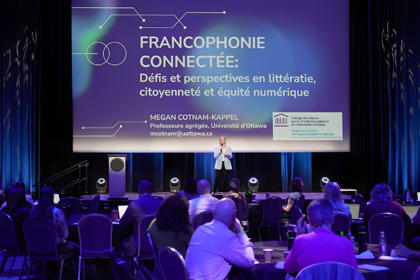 Professor Megan Cotnam-Kappel speaking on stage at a conference.