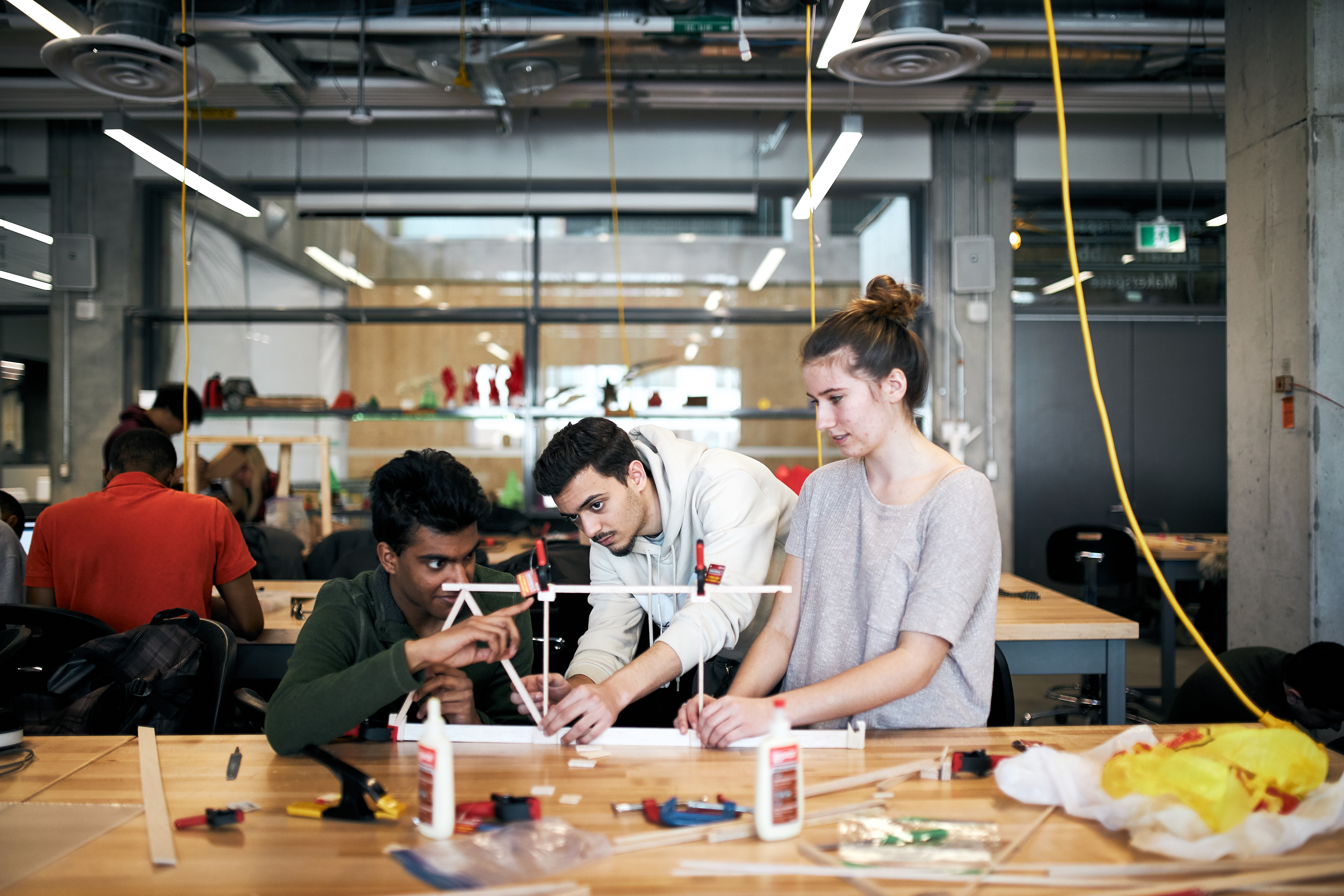Three students building a prototype at the Makerspace.