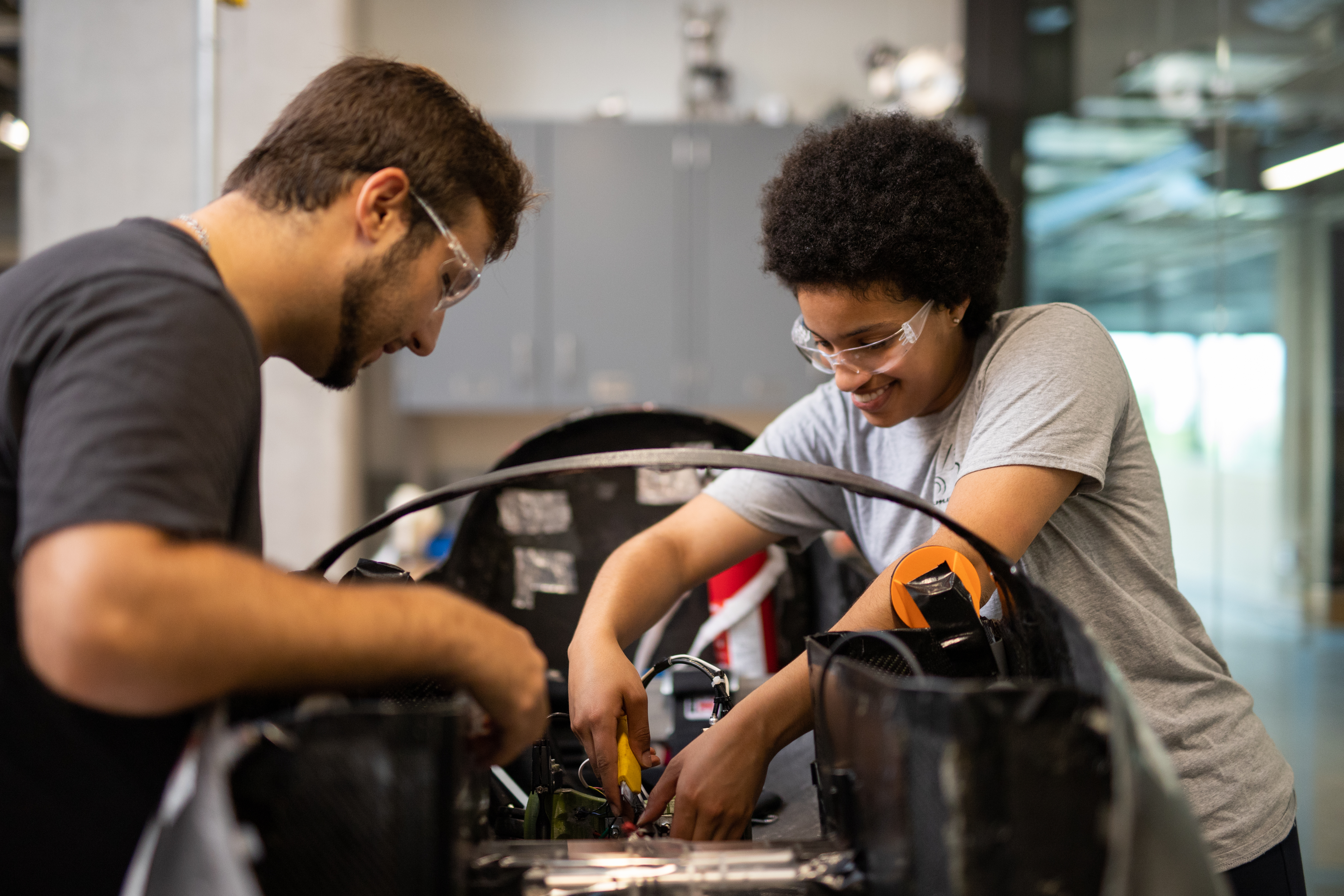 Students working on car.