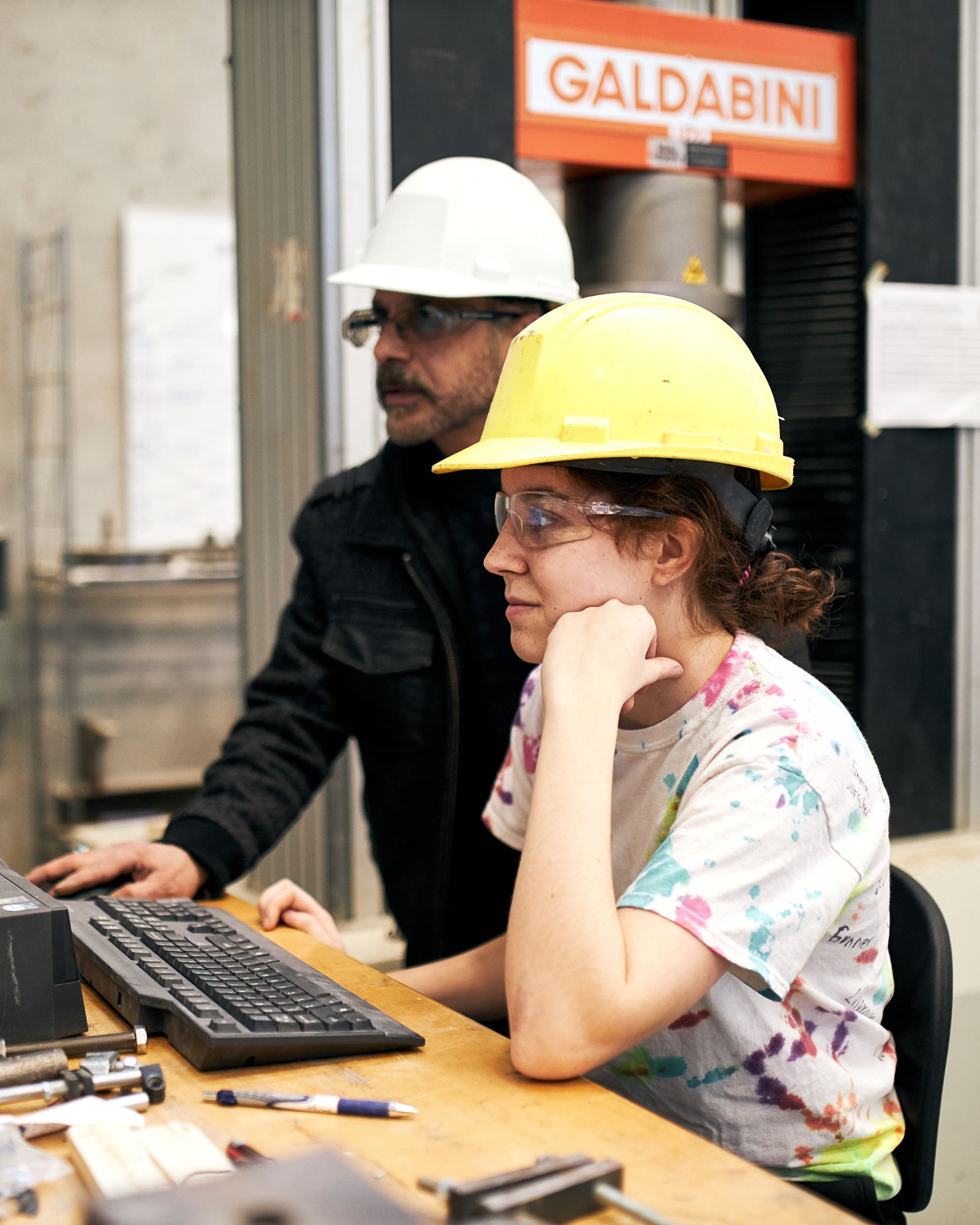 Student and professor in civil engineering lab.