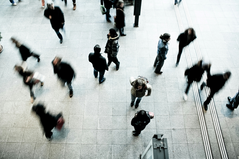 People walking in busy square.