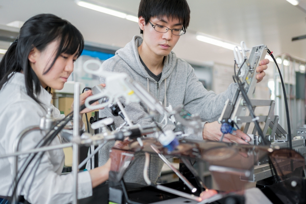 Two persons working inside a lab.