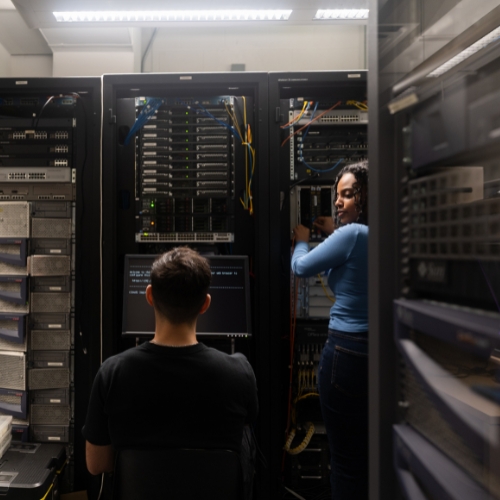 Students working in server room.