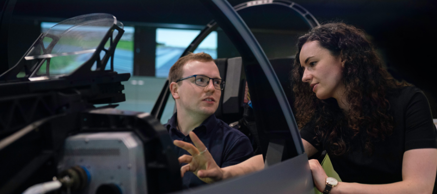 Engineers looking at a car frame.
