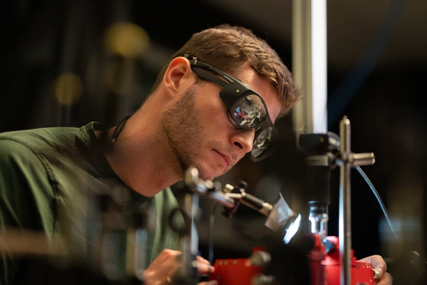 Person working with lasers in lab.