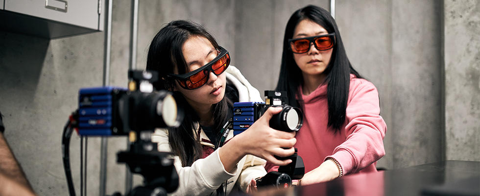 Two students testing equipment.