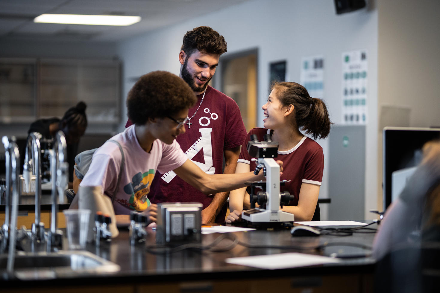 Student teaching teenagers about engineering.