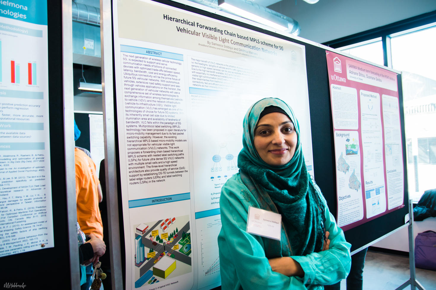 Student in front of poster presenting her research.