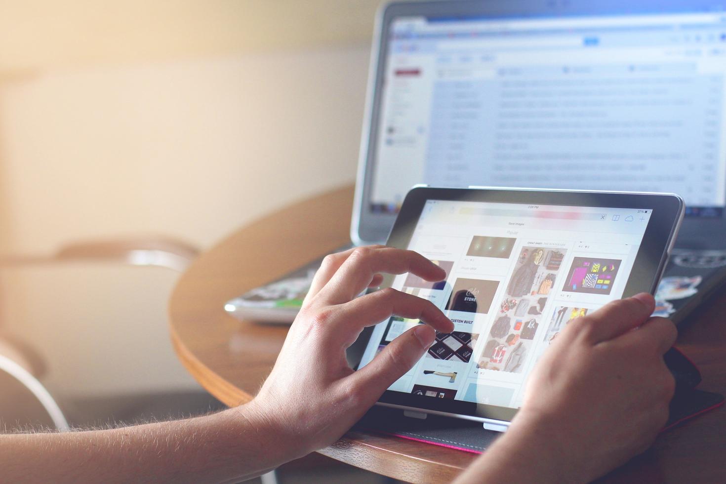 A person scrolling on a tablet.