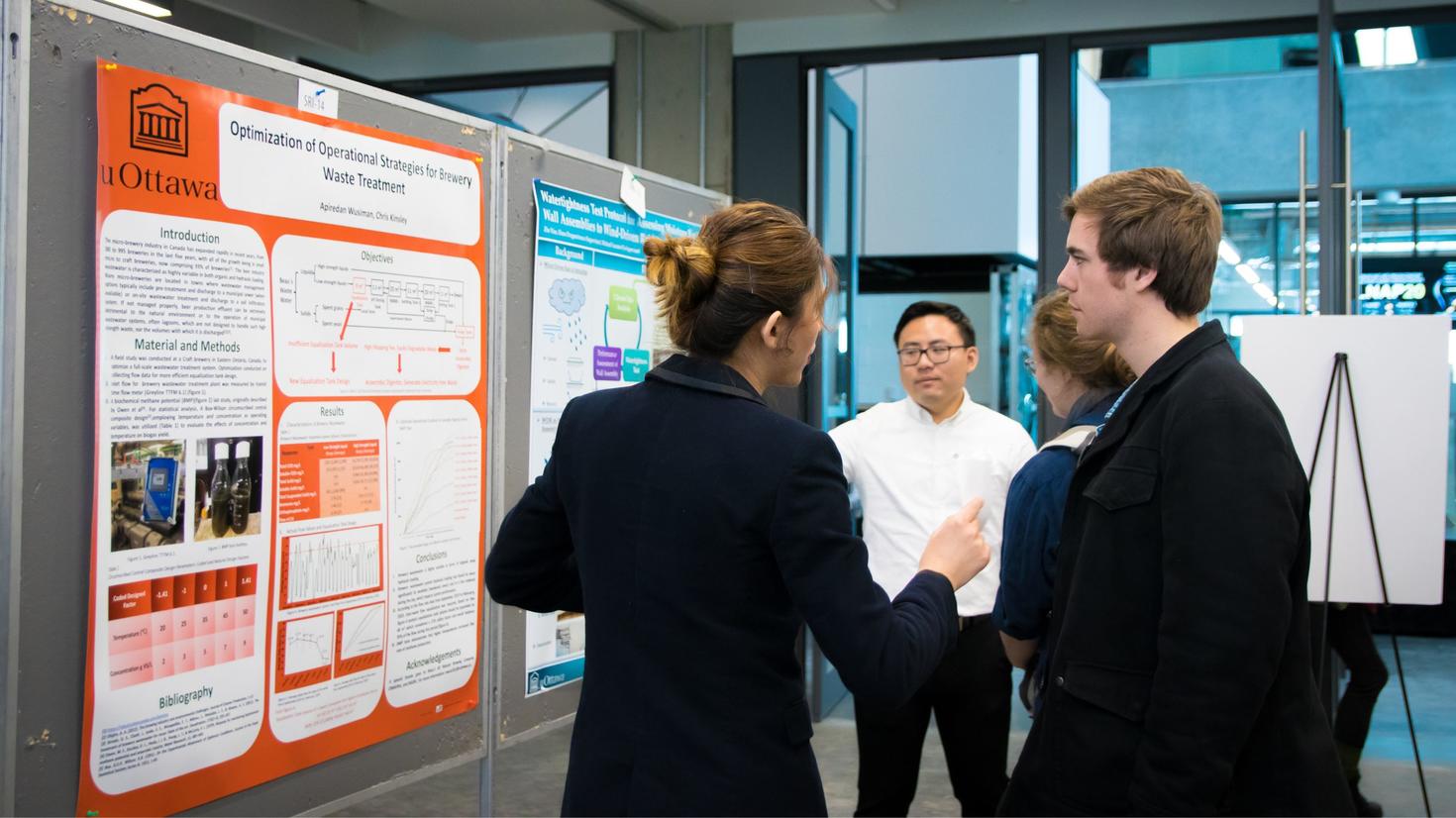 A student presents her poster during the Engineering and Computer Science Graduate Poster Competition.