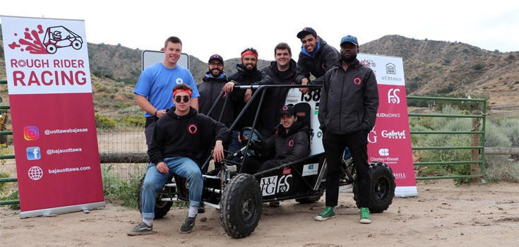 Team members with their vehicle 
