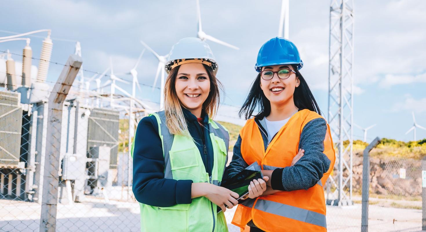 Two women standing at the center of a wind turbine