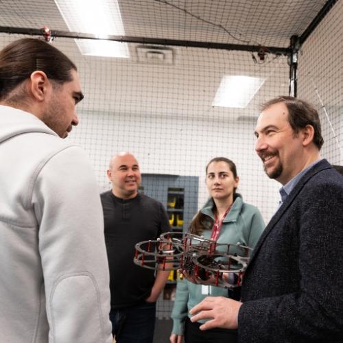 Professor and students with a robot.