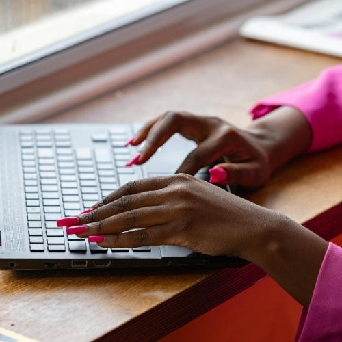 Person typing on laptop.