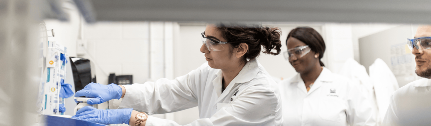 Two students in a lab working on an engineering experiment