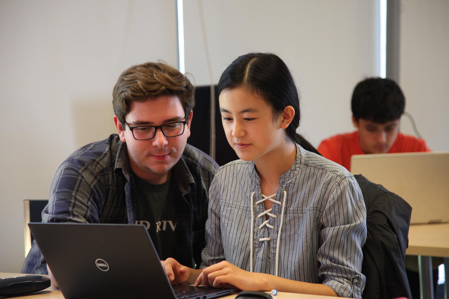 Boy and girl working on a laptop