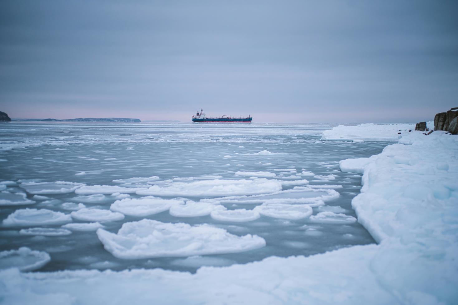 Melting ice with a boat in the water.