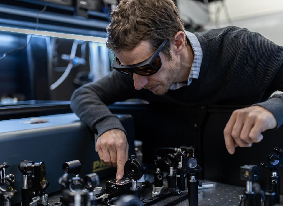 Mechanical engineering researcher working in lab.