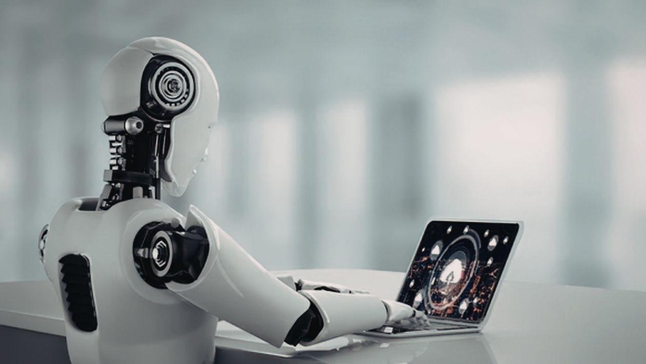 A robot uses a computer.