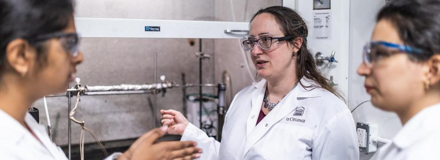 Three women in chemical engineering laboratory.