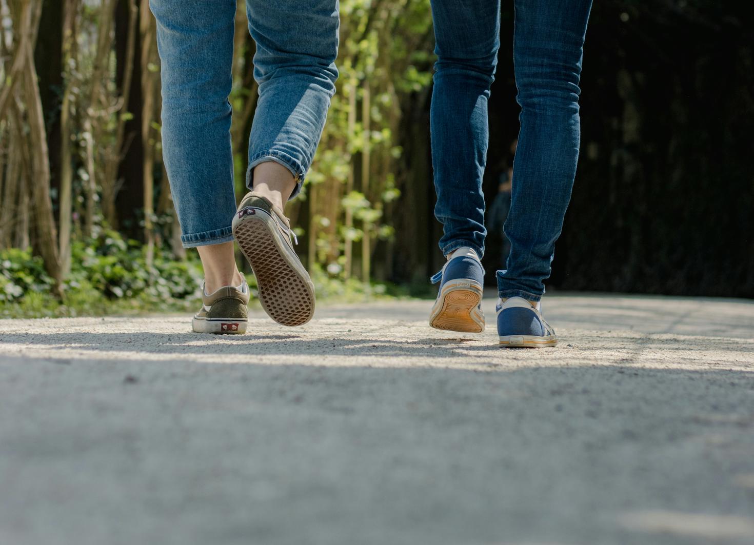 Two people walking down the street 