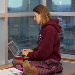 student typing on laptop 